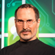 A wax image of Steve Jobs in front of a background of a computer board.